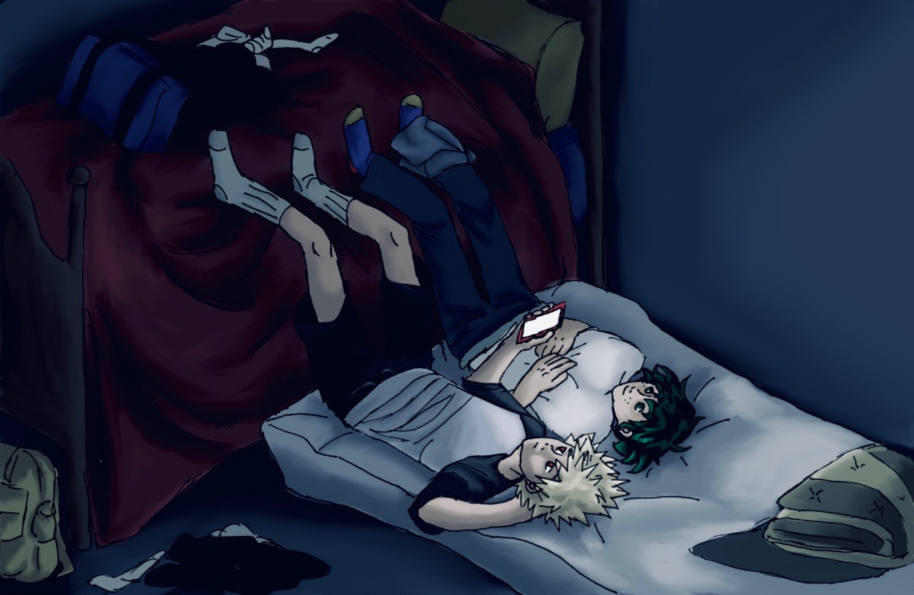 bakugou and midoriya laying on a futon with their legs up on a bed next to the futon. they're looking at the phone screen that bakugou is holding--that's the only light source in the room. there's extra clothes and their schoolbags strewn around the room